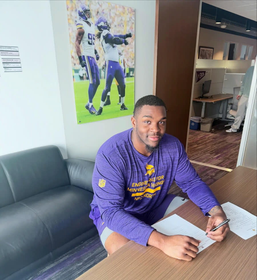 Client signing his contract at the Minnesota Vikings facility