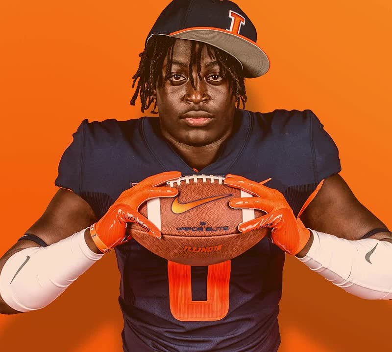 Illinois signee, number 0, holding a football